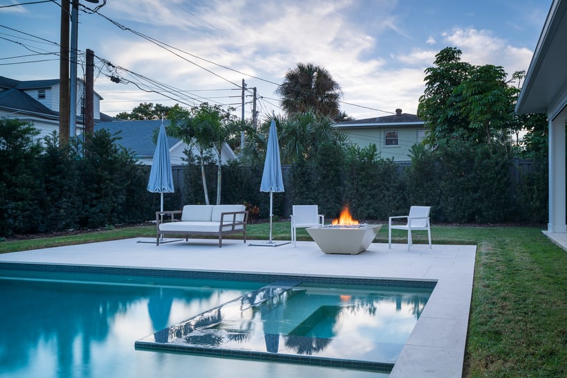 backyard pool with privacy plants