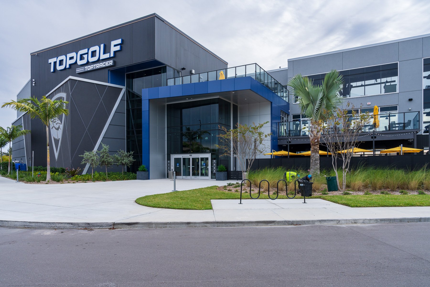 commercial landscaping crew in flower beds at Top Golf