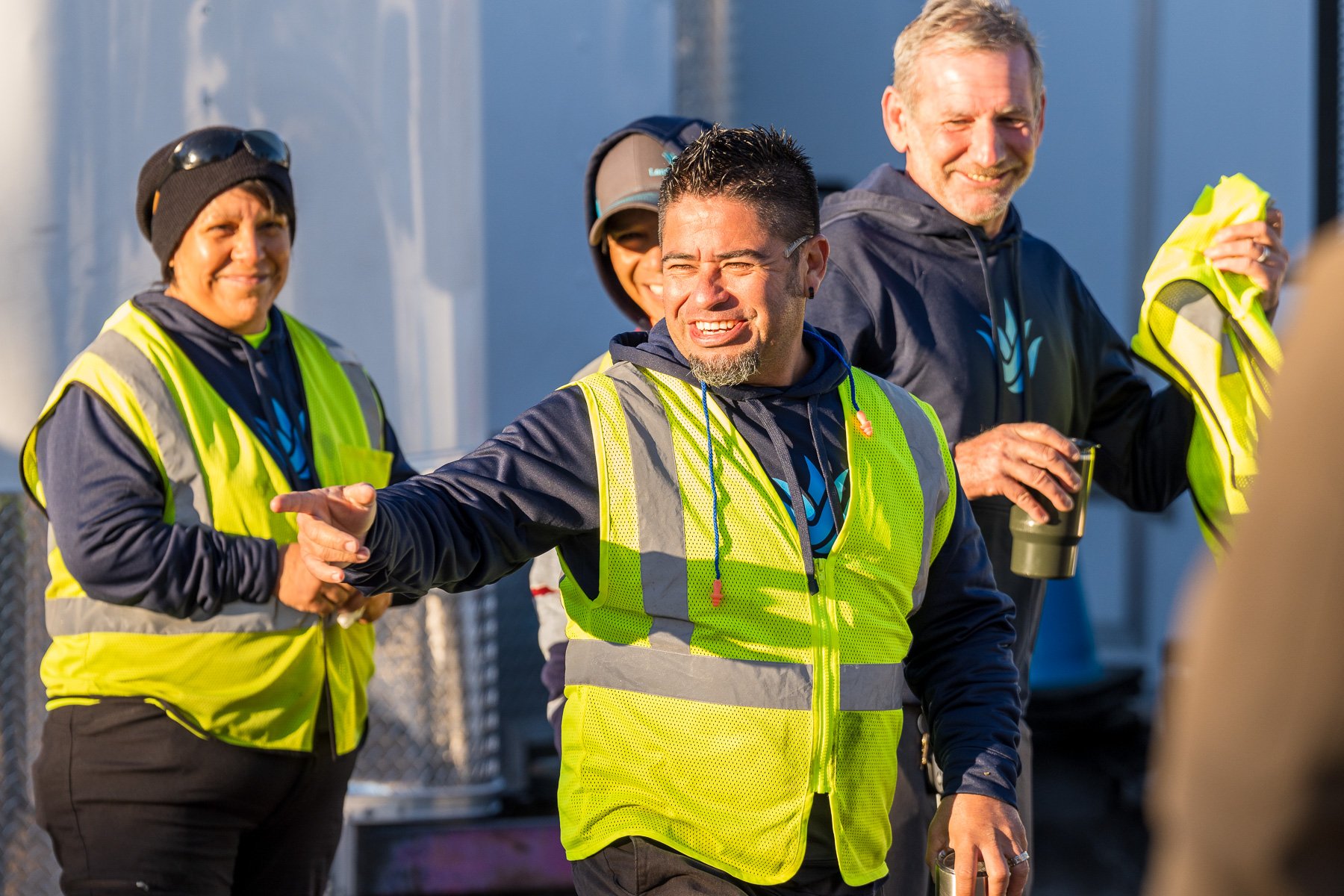 crew in yard for morning meeting -1