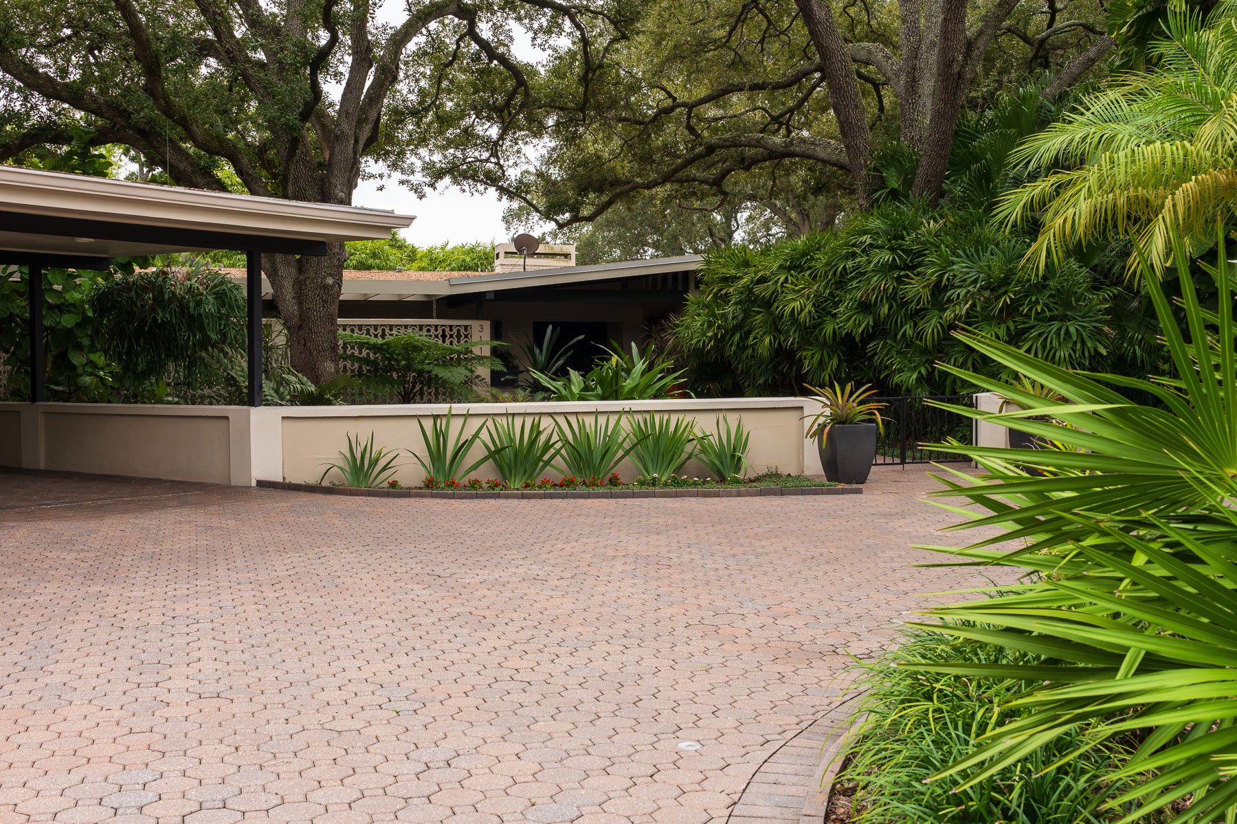 residnetial landscaping front yard along driveway with potted plants